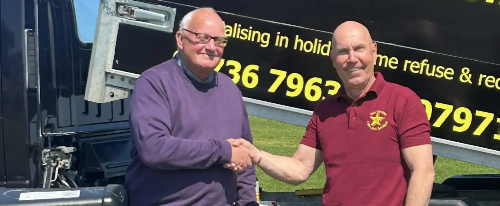 Stephen from Star Refuse shaking hands with a customer beside a branded collection lorry